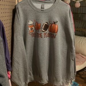 It’s the season Gildan screen printed sweat shirt. Brand new, never worn
